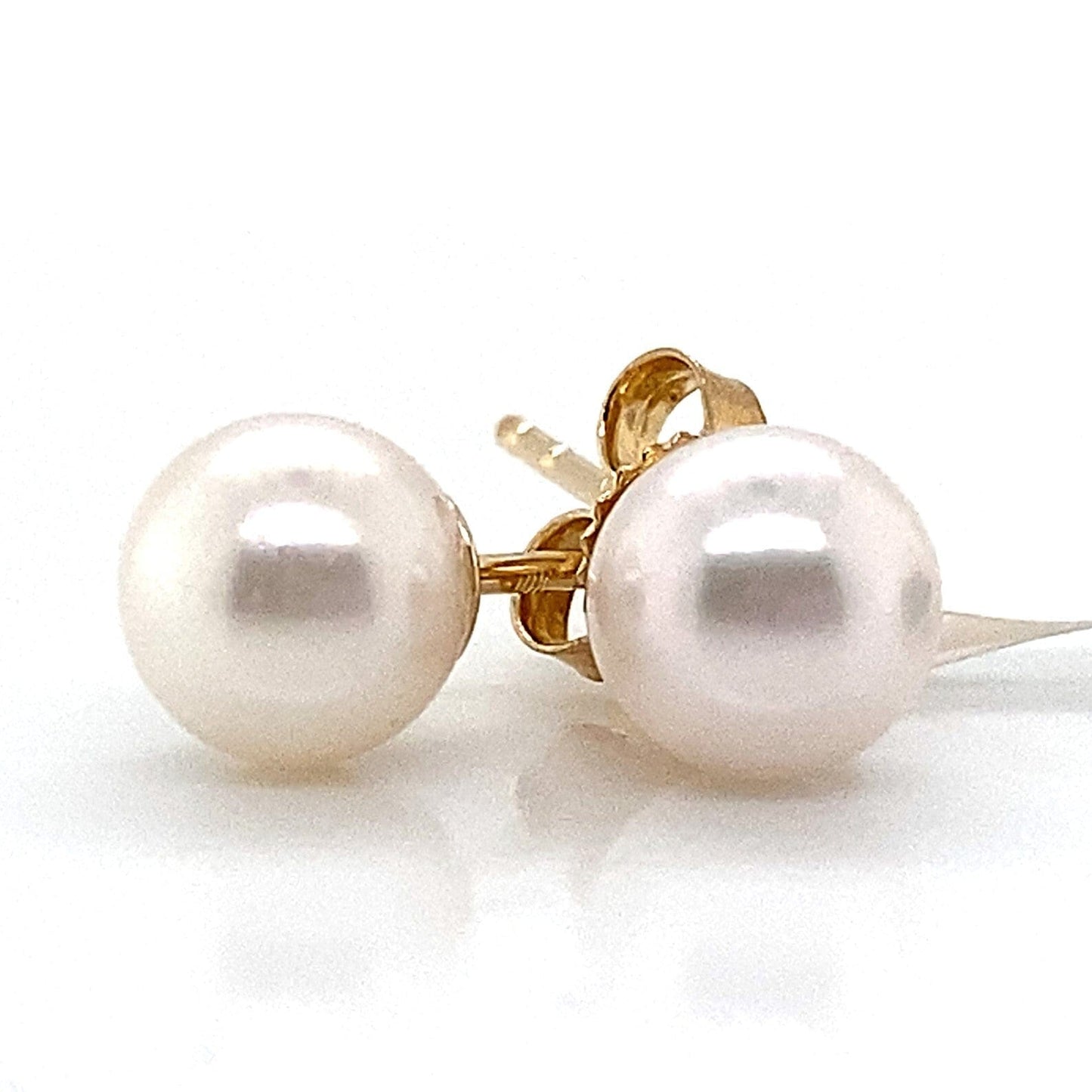 Pair of 14K yellow gold stud earrings with round 6-6.5mm white Akoya pearls.