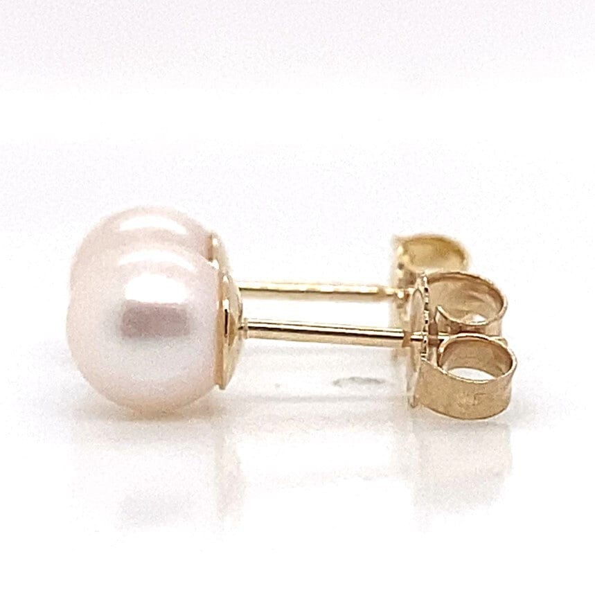 5.5-6mm white freshwater pearl stud earrings with 14K yellow gold posts and butterfly backs.