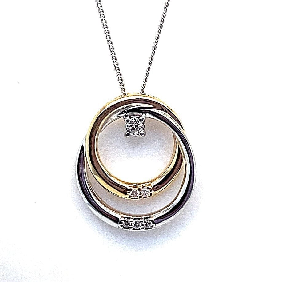 Double circle pendant necklace with yellow gold and white gold rings accented by diamonds, fashion jewelry.