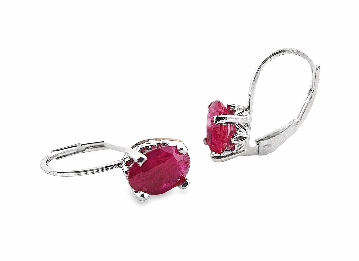 14K white gold leverback earrings with oval natural ruby gemstones.