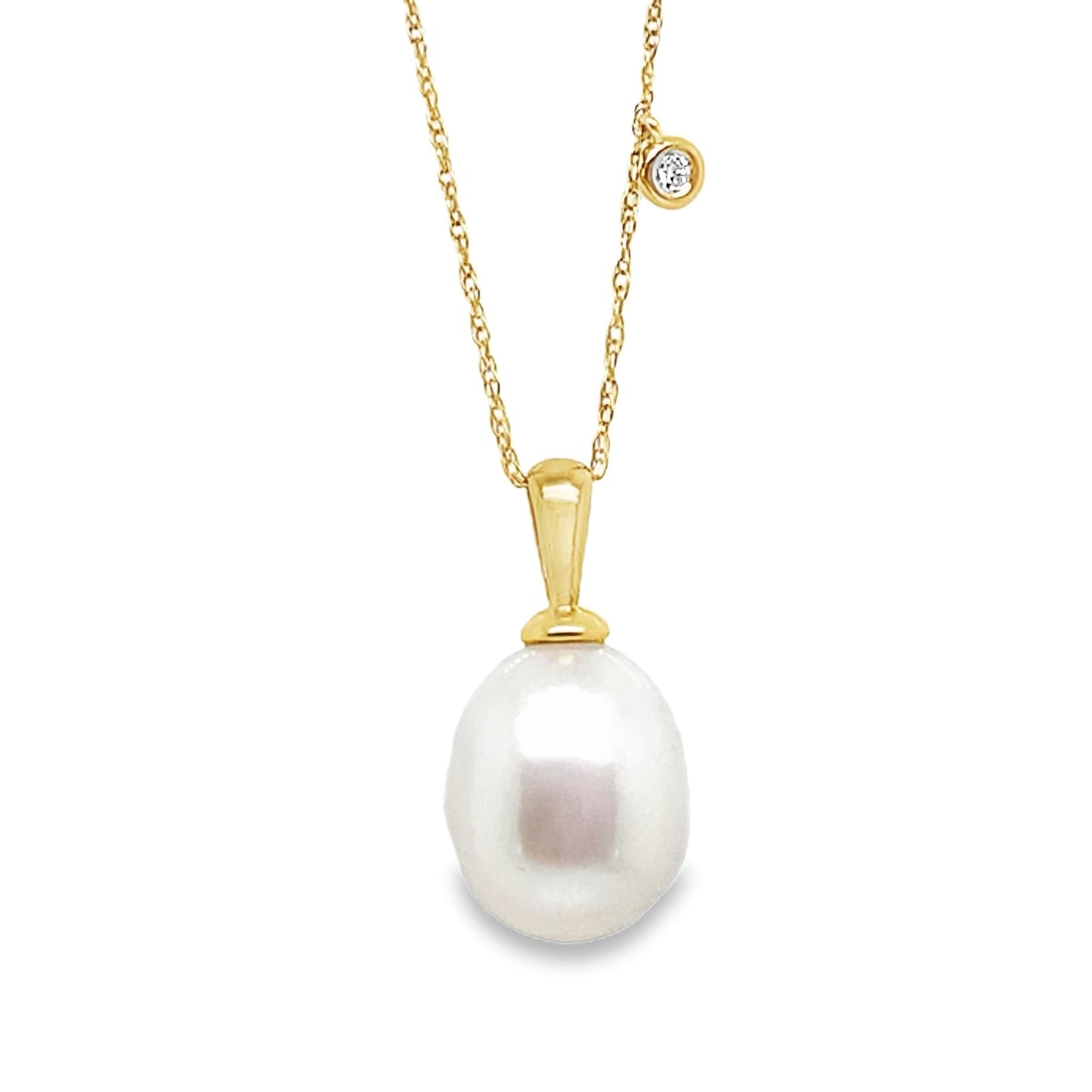 14k yellow gold necklace with large white freshwater pearl pendant and small diamond charm on delicate chain.