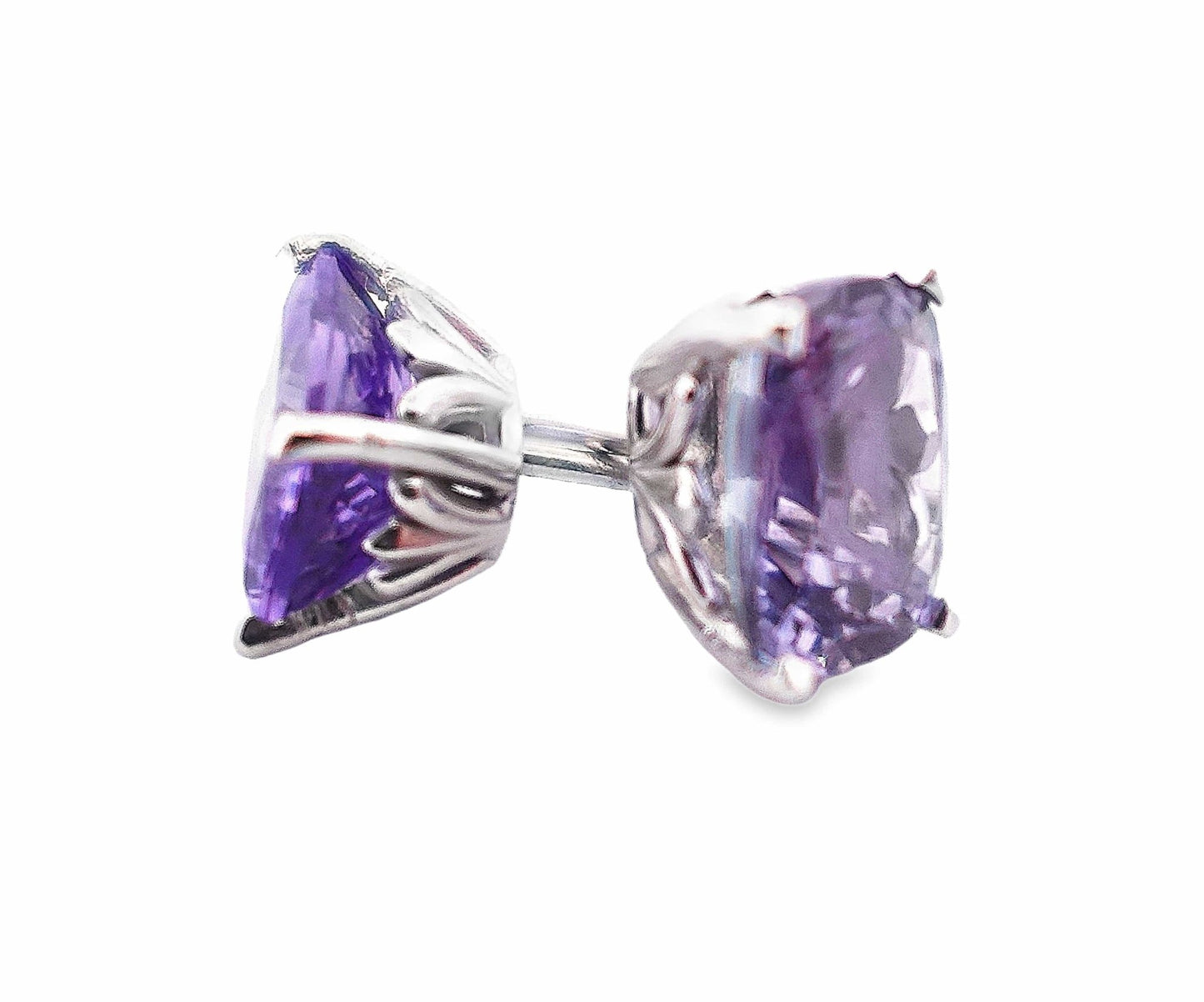 14K white gold stud earrings with cushion-cut violet tanzanite gemstones and scroll detail sides.