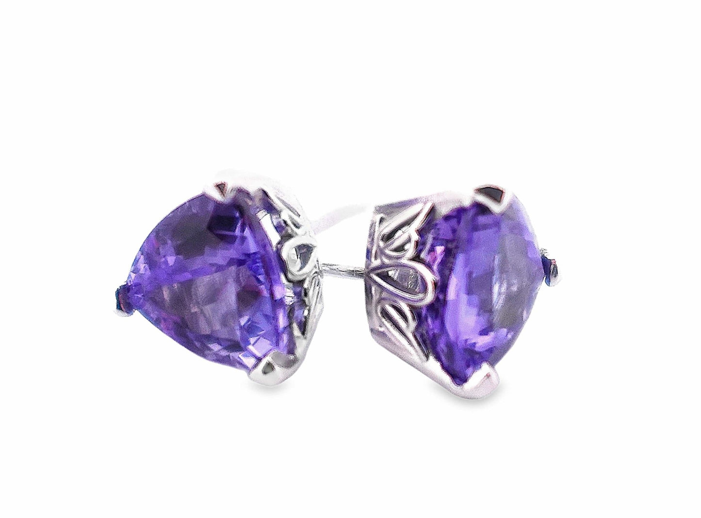 14KW white gold trillion-cut deep violet tanzanite stud earrings with scroll detail.