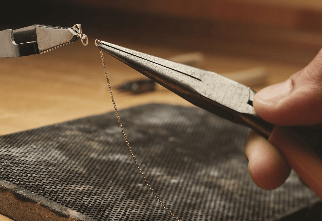 jeweler fixing clasp and chain necklace