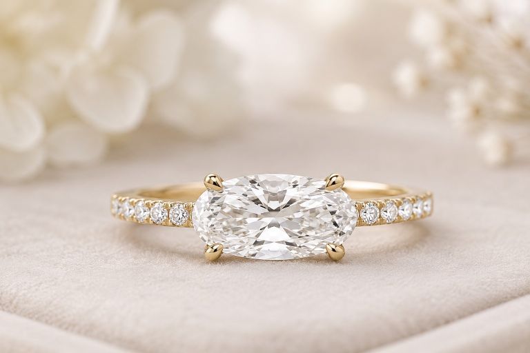 east west style engagement ring sitting on opaque surface