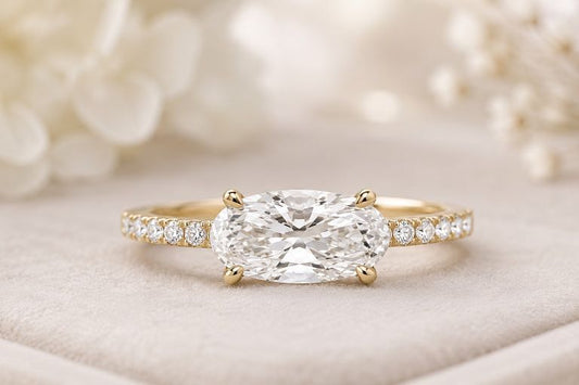 east west style engagement ring sitting on opaque surface