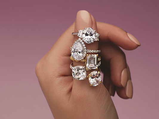 5 varied styles of engagement rings on womans finger