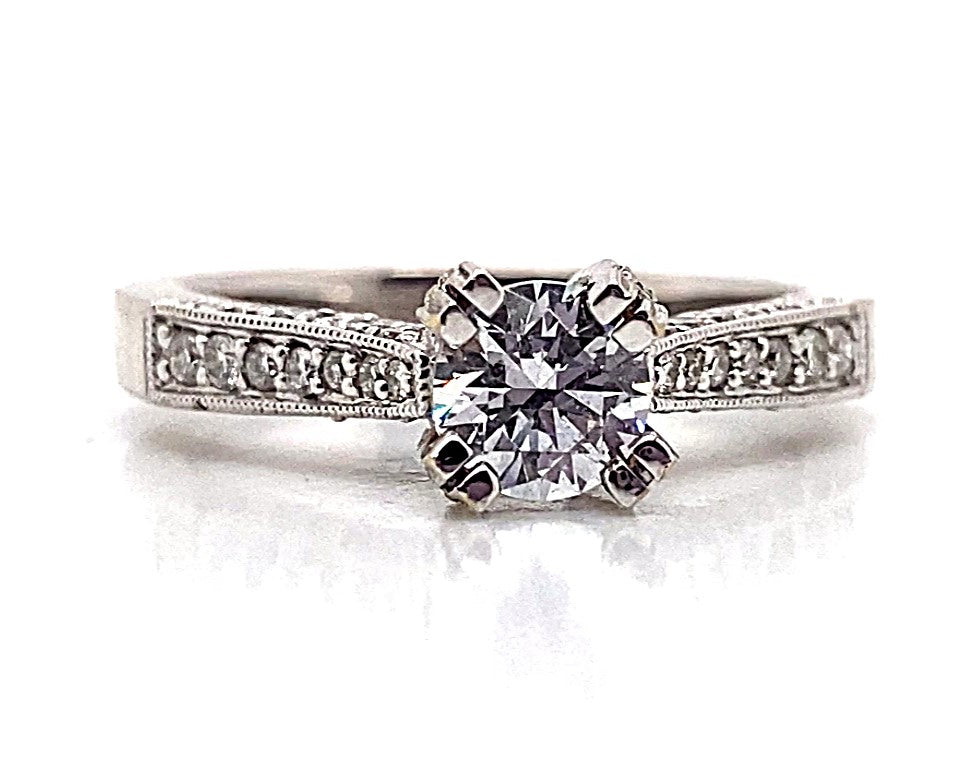 Indulge in luxury with the 18K White Gold CZ Center (6.5mm RBC) Engagement Ring, showcasing a prominent central diamond accentuated by .55TW natural round brilliant diamonds embellishing the band.