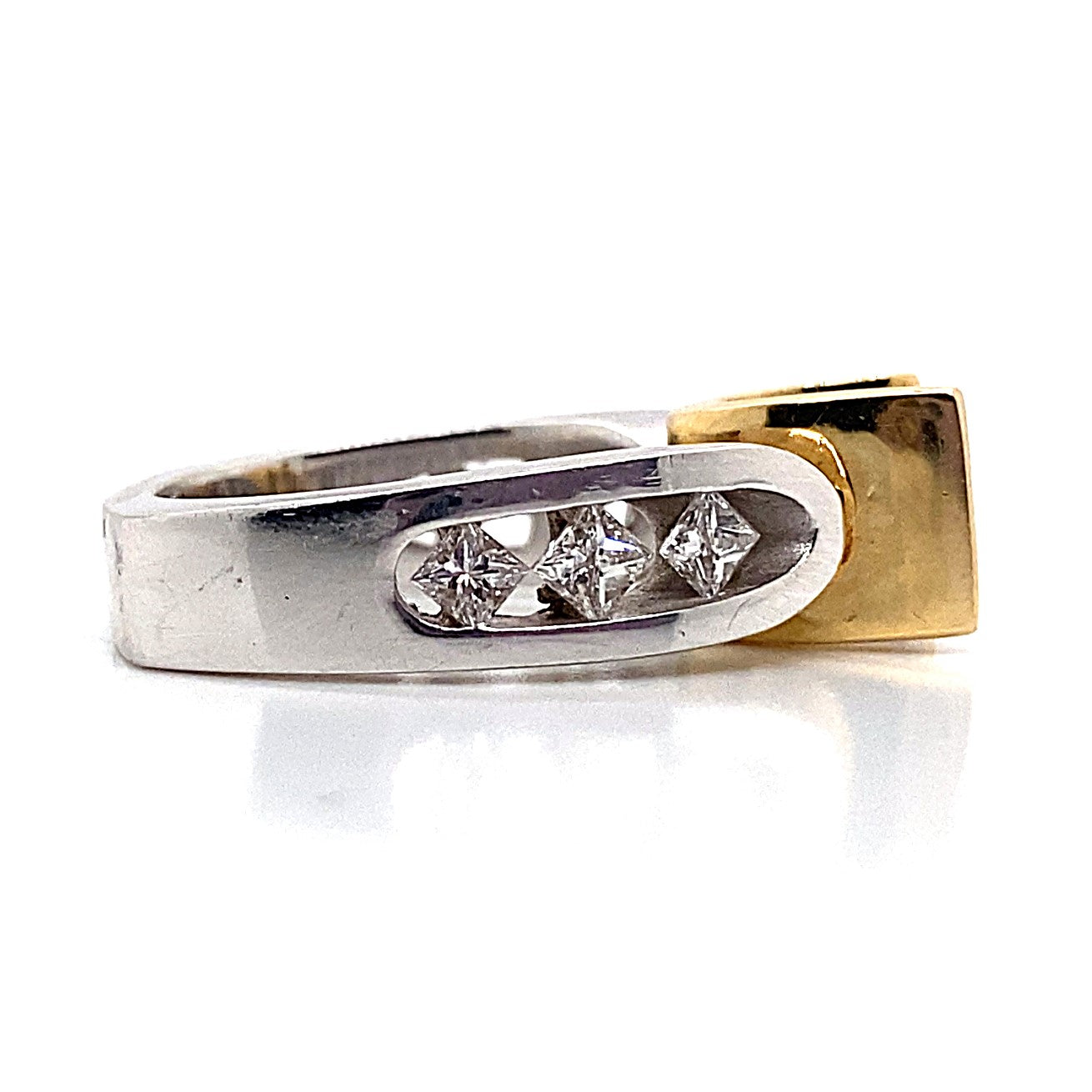 A 14K white and yellow gold ring with a silver band showcases three exquisite small diamonds in a captivating kite-set design, beautifully presented on a white surface. Known as the "14K WHITE AND YELLOW GOLD CZ CENTER (6.5 MM PRINCESS) .75 CT TW NATURAL PRINCESS DIAMOND ACCENT V-CHANNEL HEAD RING WITH A SQUARE SHANK," it exudes elegance and sophistication.