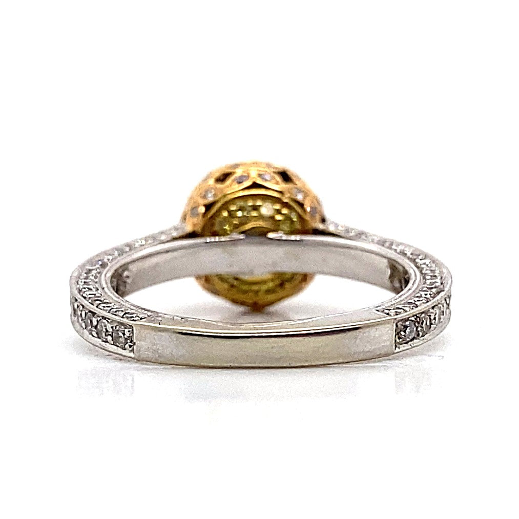 Side view of an engagement ring crafted from 18K white, rose, and yellow gold, featuring an intricate band design with a large ornate CZ center stone (6.5 mm RBC) in a yellow setting, accented by delicate .79CT TW natural round brilliant diamonds.