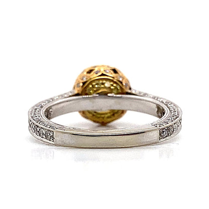 Side view of an engagement ring crafted from 18K white, rose, and yellow gold, featuring an intricate band design with a large ornate CZ center stone (6.5 mm RBC) in a yellow setting, accented by delicate .79CT TW natural round brilliant diamonds.