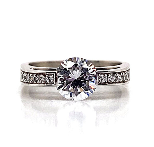 An 18K white gold engagement ring with a 7mm CZ center and .20 CT TW natural round brilliant accent stones.