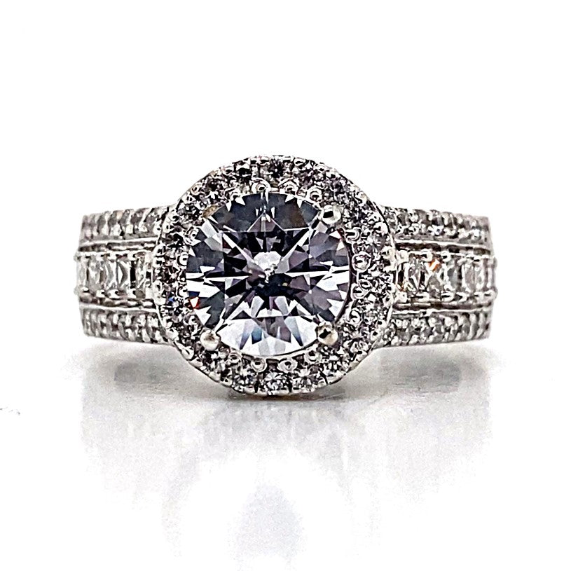 14K white gold ring showcasing a stunning princess and round brilliant cut diamond halo style, highlighted by a dazzling 1.35 carat CZ center and sparkling diamond accents along the band.