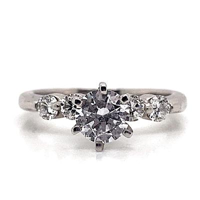 Make a sophisticated proposal with the stunning 14K White CZ Center (6.5mm RBC) .40 CT TW Natural Round Brilliant Diamond Accent Ring, featuring a central CZ center stone flanked by two smaller diamonds.