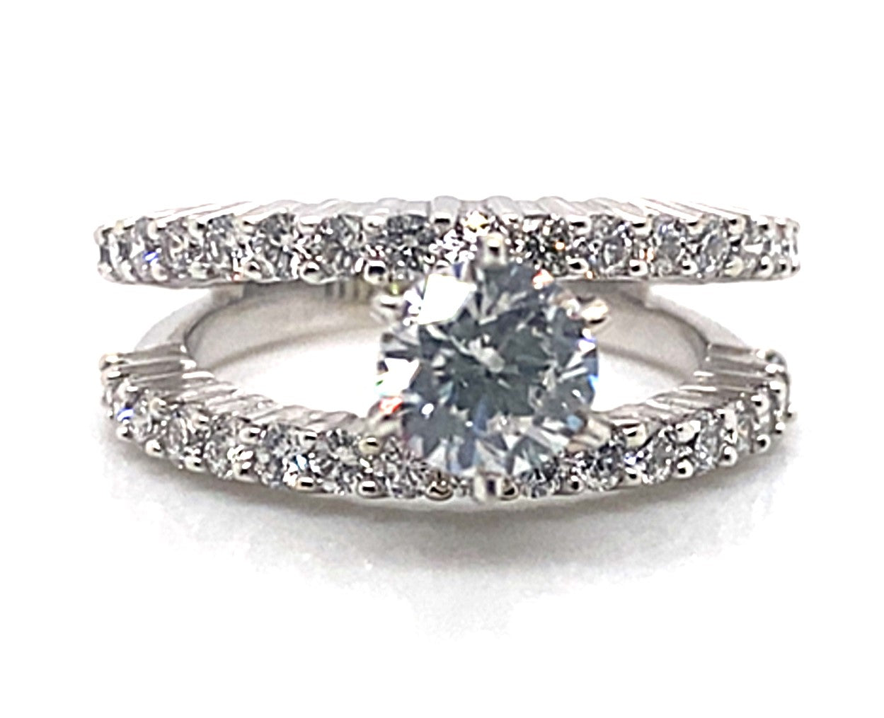 A 14K white gold double band ring has a 6.5 mm round CZ center and diamond accents on the split shank style bands.