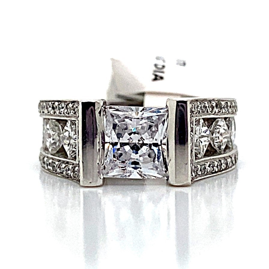 A striking 14K white gold ring with a 7mm princess-cut center stone, featuring a floating princess style adorned with natural princess and round brilliant diamond accents.