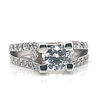 Introducing the 14K White Gold CZ Center Ring, featuring a 6.5 mm round brilliant cut center stone, adorned with 1.10 ct natural round brilliant and princess diamond accents along a square shank.