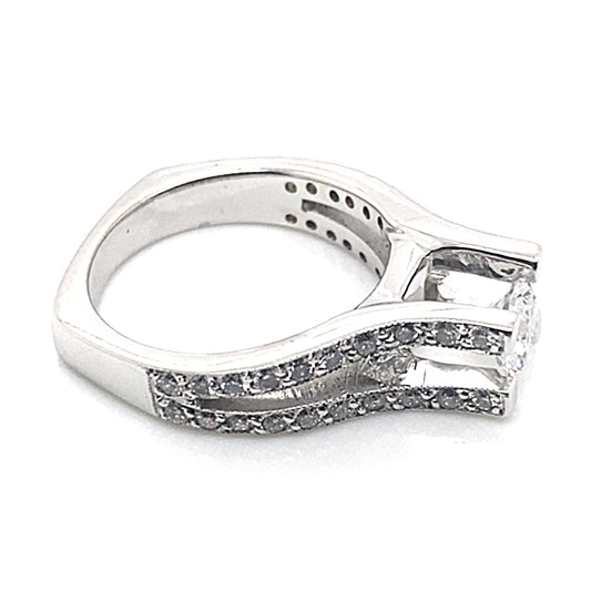 A captivating 14K white gold ring showcasing a 6.5 mm RBC CZ center, beautifully enhanced by 1.10 ct natural round brilliant and princess diamond accents along the band with a square shank design.