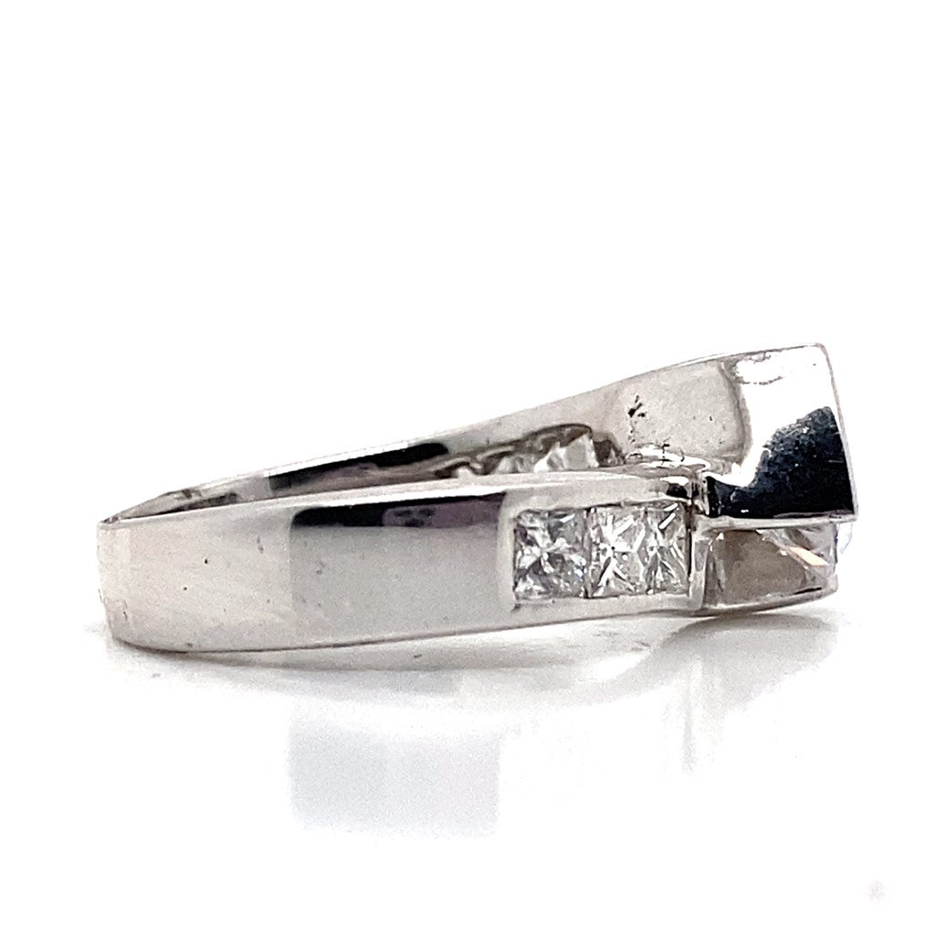 14K white gold bypass style ring featuring a 7mm round brilliant cut cubic zirconia center, highlighted by .90 carats total weight of natural princess-cut diamond accents set in channels.