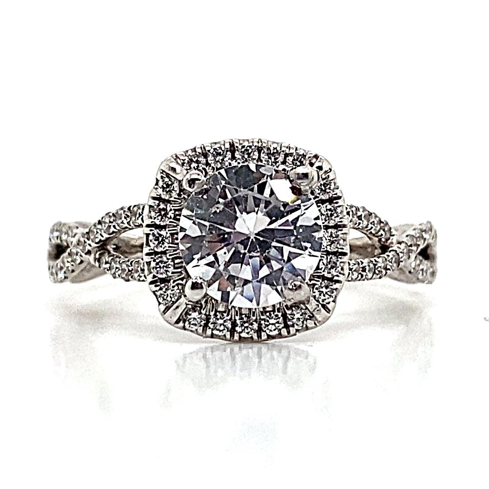 A captivating 14K white gold ring showcasing a prominent 6.5 mm RBC CZ center, .30 carat natural round brilliant diamond accents, and an elegant infinity halo style with delicate diamond detailing on the band.