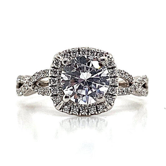 A captivating 14K white gold ring showcasing a prominent 6.5 mm RBC CZ center, .30 carat natural round brilliant diamond accents, and an elegant infinity halo style with delicate diamond detailing on the band.