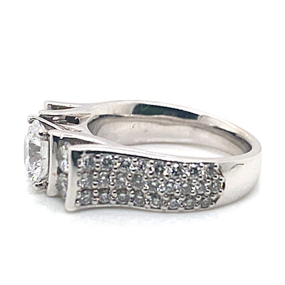 14K WHITE GOLD LADIES ENGAGEMENT RING showcasing a large central gemstone accented with 1.40 CT TW CZ in a channel side pave design along the band.