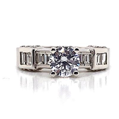 Platinum ring with a 6 mm round brilliant cubic zirconia center and .30 carat total weight natural baguette diamond accents set in a channel setting.