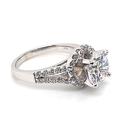 This 14K white gold split shank halo style ring perfectly combines sophisticated design with radiant elegance, showcasing an 8 mm oval CZ center surrounded by dazzling .70 ct TW natural round brilliant diamond accents delicately set along the band.