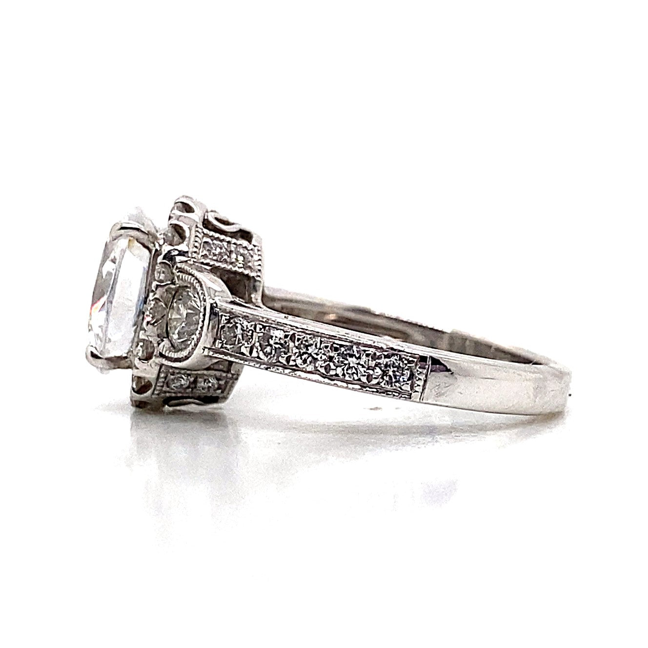 14K white gold engagement ring with a prominent oval center stone surrounded by natural round brilliant diamond accents, showcasing an elegant halo design and intricate detailing on the band.