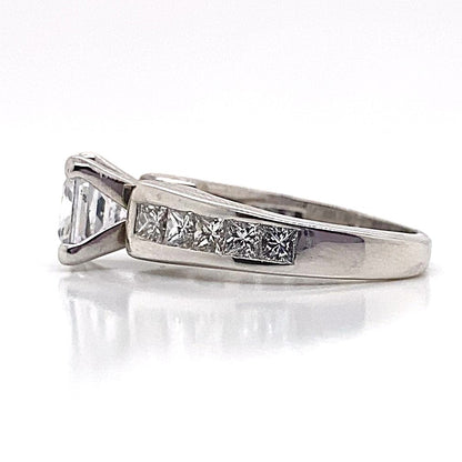 For a sophisticated proposal, choose the elegance of the 14K White Gold CZ Center Ring. This exquisite piece boasts a 6.5 mm princess cut centerpiece and natural diamond accents in a channel set cathedral style, all beautifully presented on a pristine white gold band.