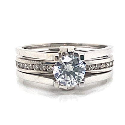 This exquisite wedding ring set, crafted from 14K white gold, showcases a 5.25mm CZ center stone and is adorned with .30 carat total weight of natural diamond accents.