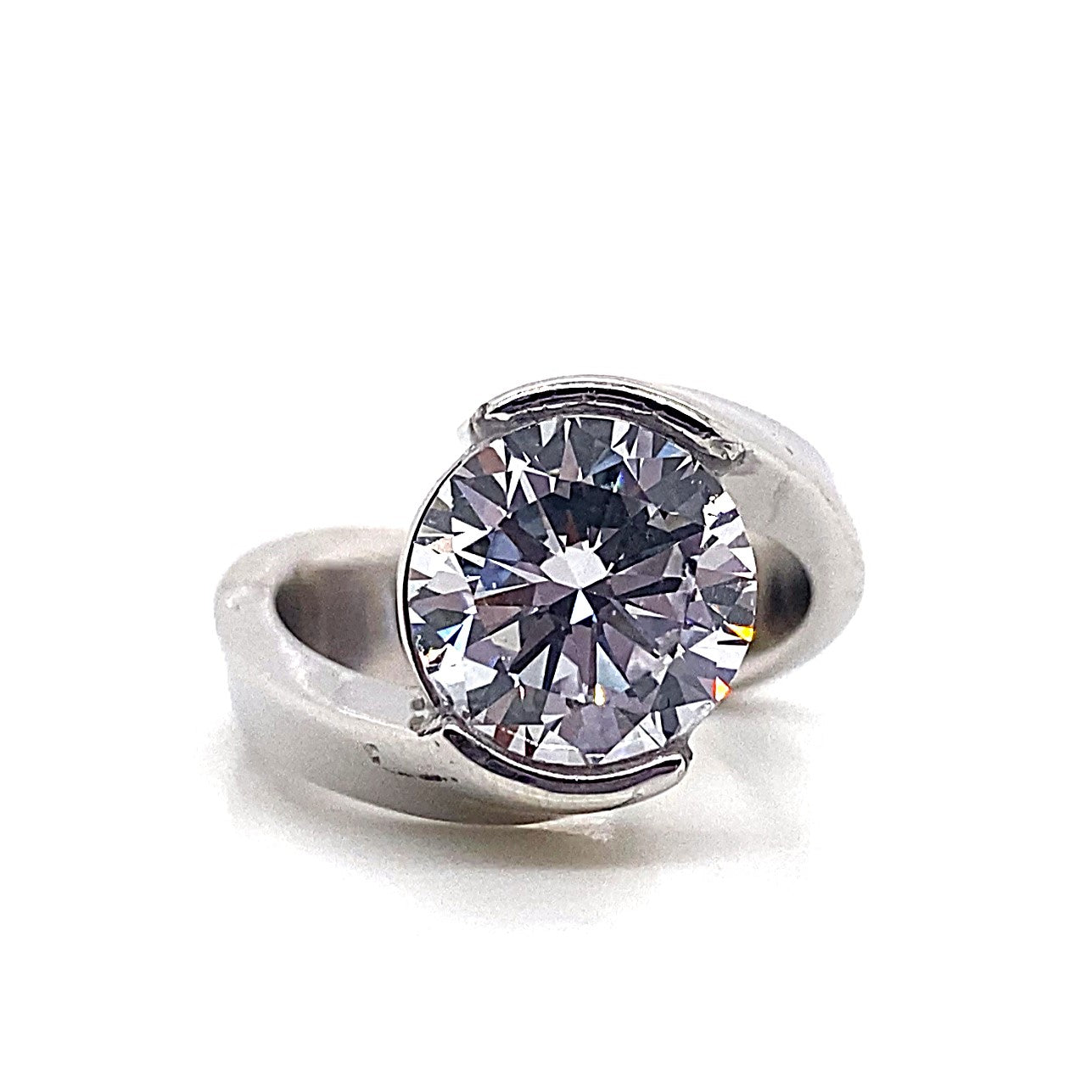 14K white gold engagement ring showcasing a 9.5mm round cubic zirconia center stone, set in a half bezel bypass design, accented with .20 carats total weight of natural round brilliant diamonds.