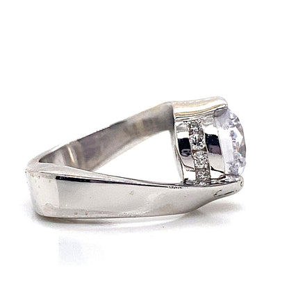 14K white gold engagement ring featuring a 9.5mm round brilliant cubic zirconia center stone and .20 carat total weight natural round brilliant diamond accents, displayed in a half bezel bypass style, viewed from the side.