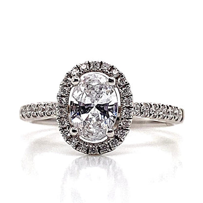 A classic beauty, this 18K white gold engagement ring features a CZ center and .35 CT TW accent halo.