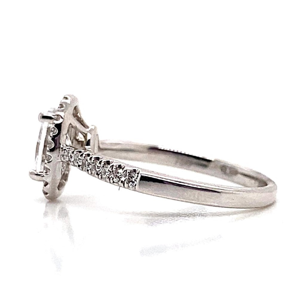 A classic 18K white gold engagement ring with a center CZ and accent halo diamonds on the band.