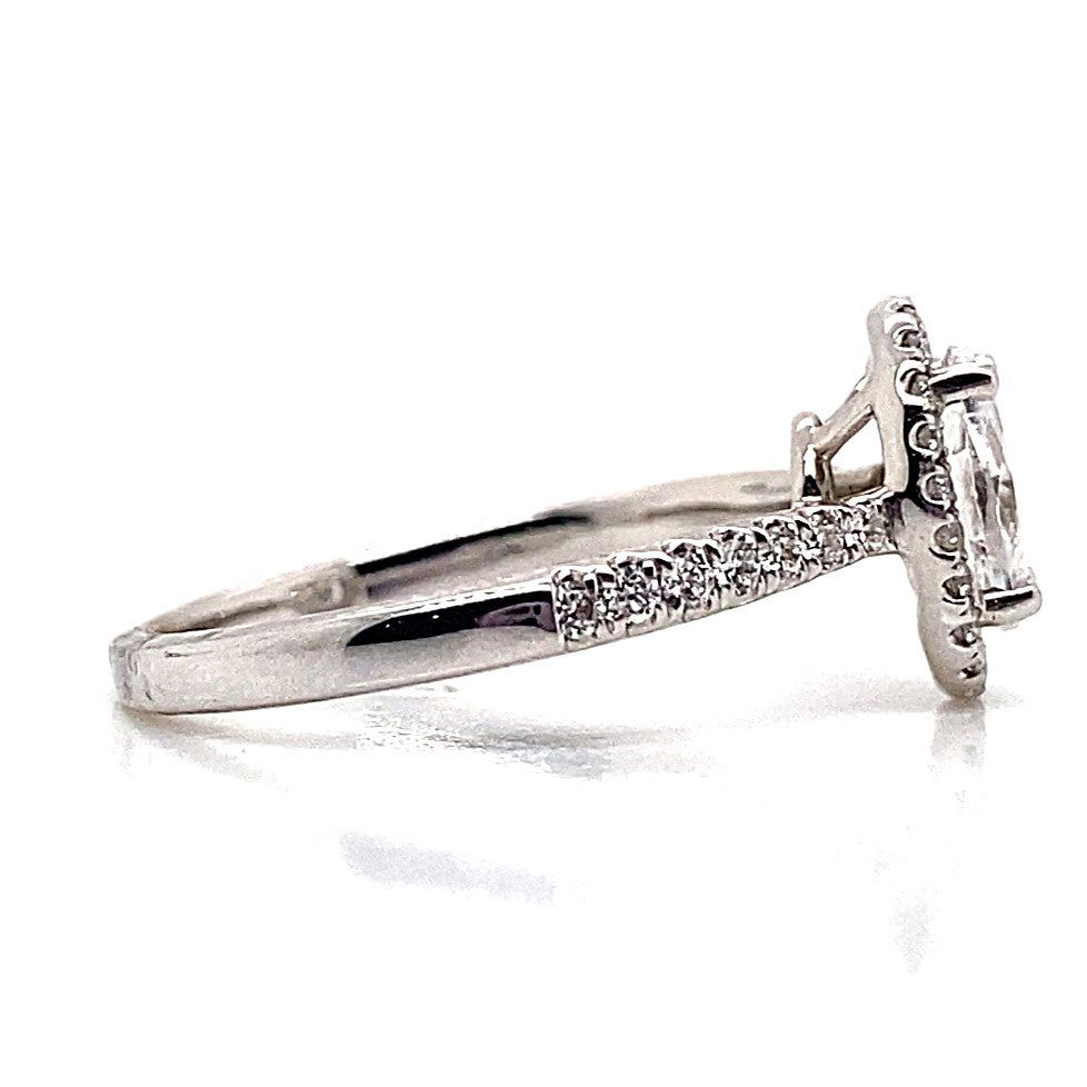 Side view of an 18K white gold halo engagement ring with a CZ center stone and .35 CT TW accent diamonds on the band.