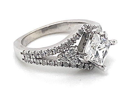 Introducing a breathtaking engagement ring made from 14K white gold. It features a 6mm princess-cut CZ centerpiece and natural round brilliant diamond accents along the band, complete with a square shank design.