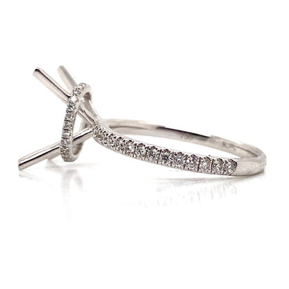 A luxury 18K white gold hidden halo ring with .39 CT TW diamonds, shown from the side.