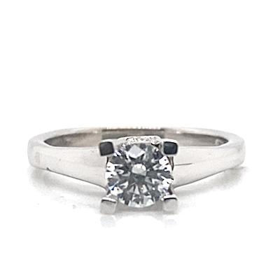 A 14K white gold ring with a CZ center and .25 CT TW diamond accents, set in a four-prong setting.