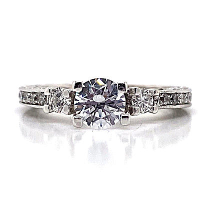 A stunning 18K white gold ring with a CZ center and diamond accents in a scalloped design.