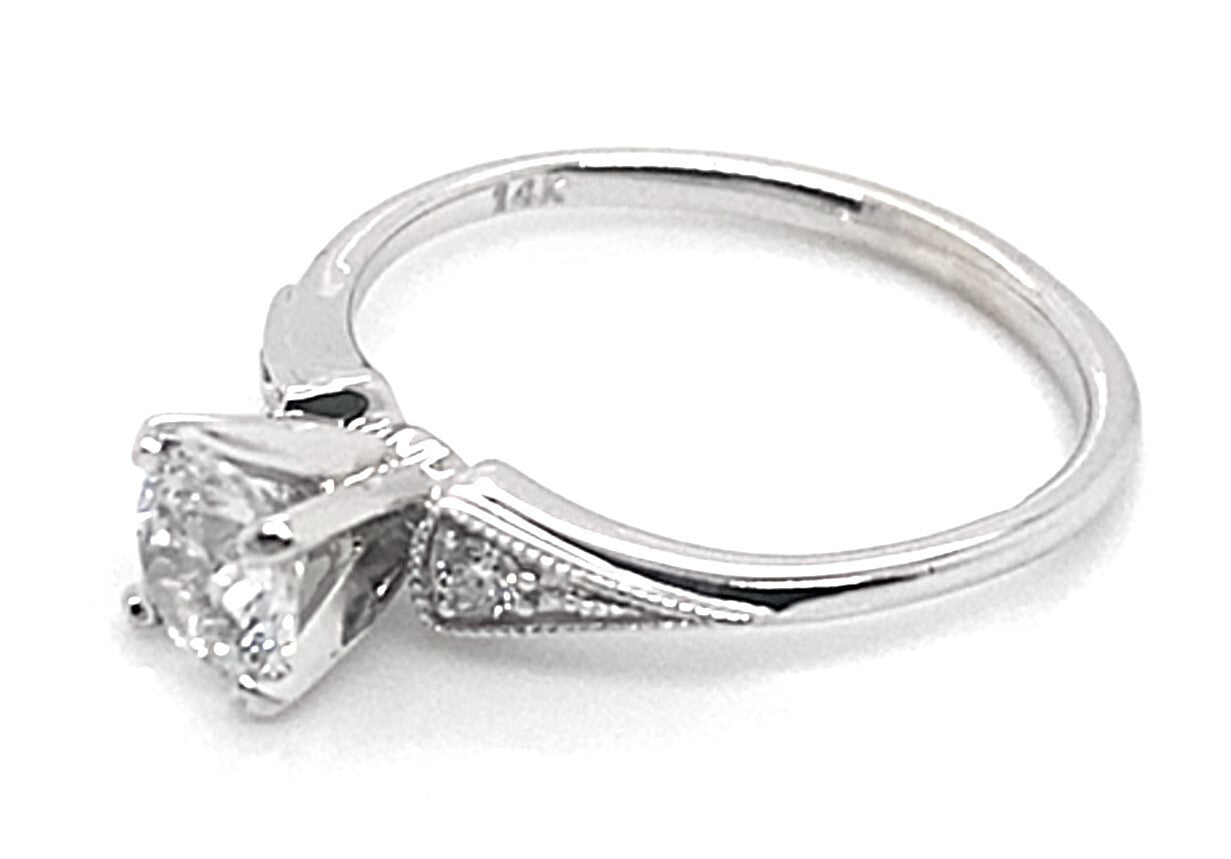 Engagement ring crafted in 14K white gold, showcasing a 6mm round brilliant CZ center stone enhanced by natural round brilliant diamonds totaling .10 carats along the band.