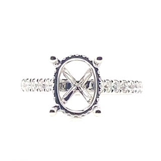 18K white gold ring with an 8x10 mm oval setting, detailed band, and 0.60 ct tw diamond accents in a hidden halo style.