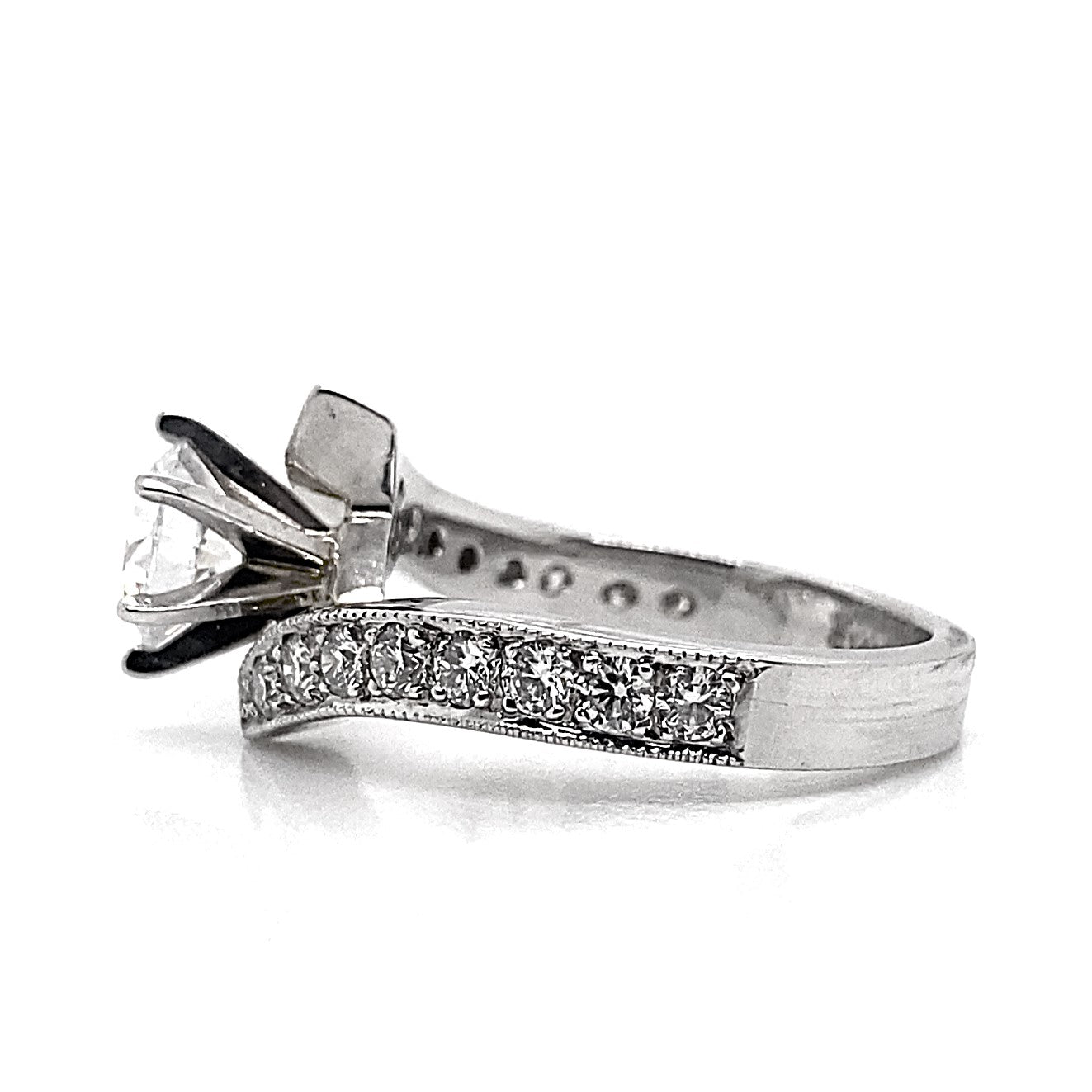 A 14K white gold ring adorned with a 6.5mm round brilliant-cut center stone and .60 carat total weight of natural round brilliant accent stones, featuring an exquisite bypass design with millgrain pave style detailing.