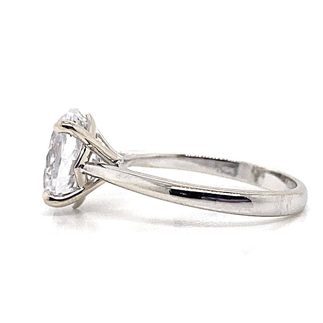 A beautiful solitaire ring fashioned from 14K white gold, showcasing a prominent oval cubic zirconia (11x9mm) set in a graceful prong setting.