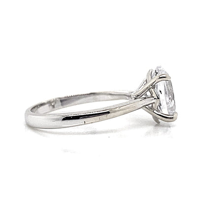 A 14K white gold solitaire ring showcasing an oval-shaped CZ center stone measuring 11x9mm in a prong setting.