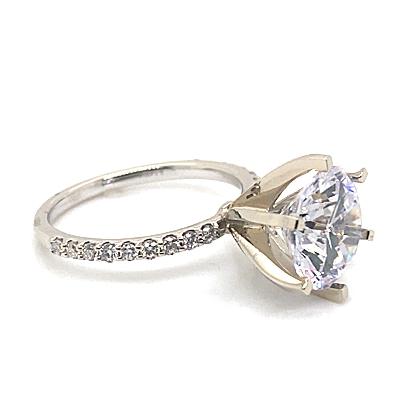 An exquisite 14K white gold ring showcasing a prominent 10mm RBC CZ center stone, enhanced by natural round brilliant diamond accents totaling 1/5 ct along the band.