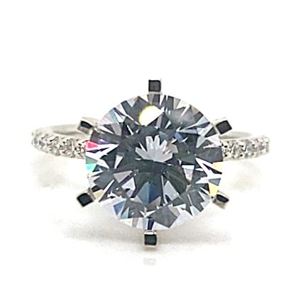 The 14K WHITE GOLD CZ CENTER (10MM RBC) ring showcases a captivating CZ center stone and is enhanced by 1/5 CT TW natural round brilliant diamond accents on the band, making it a stunning statement piece.