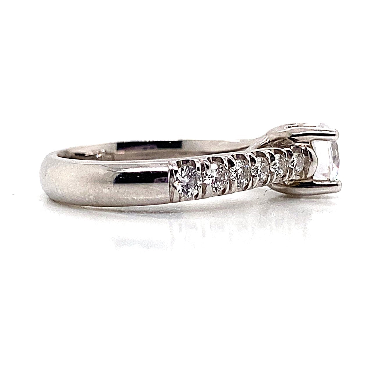 14K white gold ring showcasing CZ center (6.25 mm RBC) with a total weight of .78 carats in natural round brilliant diamond accents, elegantly set in a fishtail style, featuring a row of smaller diamonds leading to a larger central stone on a smooth backdrop.