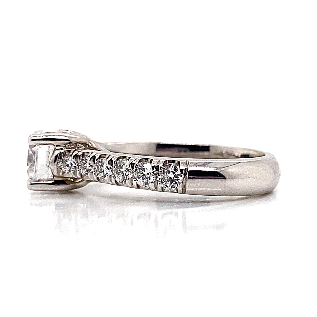 A stunning 14K white gold ring with a 6.25 mm round brilliant cubic zirconia centerpiece and a total weight of .78 carats of natural round brilliant diamond accents, elegantly set in a fishtail style.