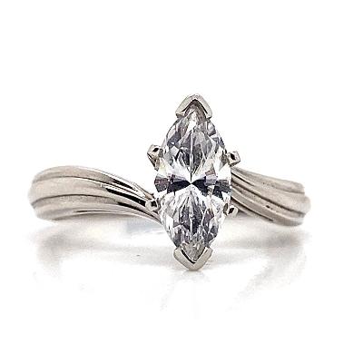 The 14K White Gold CZ Center Grooved Bypass Style Solitaire Ring showcases a 10x5mm marquise-cut stone and a sophisticated twisted band, offering timeless elegance.